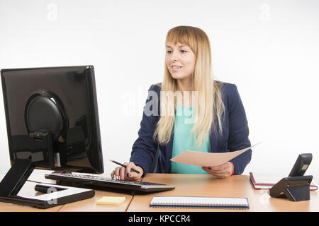 Happy business donna guardando il computer i dati desiderati nell'elenco documenti Foto Stock
