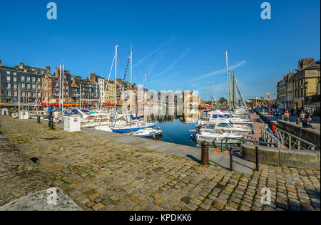 Il vecchio molo presso il pittoresco villaggio francese sulla costa della Normandia al canale in inglese, Honfleur, in una giornata di sole con le barche in acqua Foto Stock