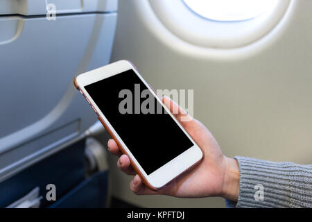 Azienda telefono mobile digitale in aereo Foto Stock