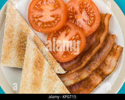 La pancetta e pomodoro con Toast contro uno sfondo blu Foto Stock