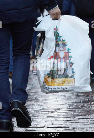 Amburgo, Germania. Xvi Dec, 2017. Un uomo che porta una borsa da shopping con un'immagine di uno schiaccianoci presso il municipio sulla piazza del mercato di Amburgo, Germania, 16 dicembre 2017. Credito: Georg Wendt/dpa/Alamy Live News Foto Stock