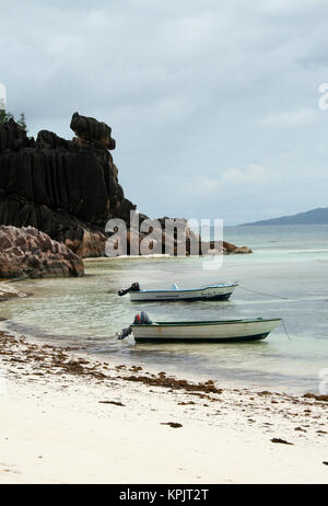 Barche di pescatori sulla costa di Isola Curieuse, Seychelles. Foto Stock