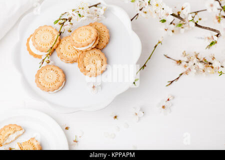 Cookies su piastra bianca con il fiore susino Foto Stock