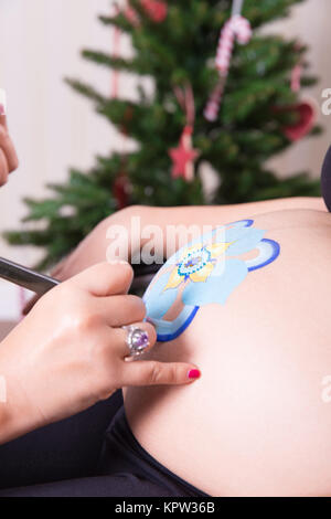 Natale pittura del ventre Foto Stock