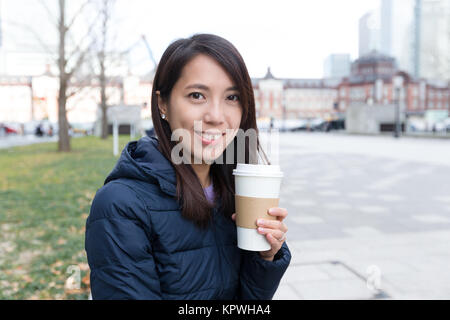 Donna con caffè all'aperto Foto Stock