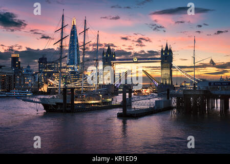 Tramonto su Tower Bridge, London, con cancelli sollevato e viaggio in barca attraverso Foto Stock