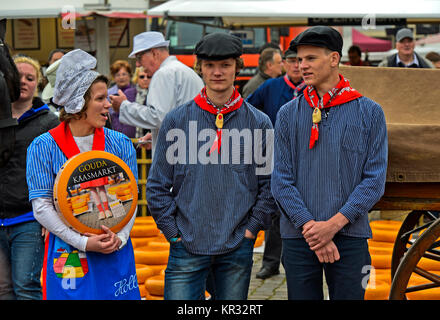 Formaggio olandese la ragazza con il formaggio Gouda truckle e due ragazzi di formaggio, il mercato dei formaggi Gouda, Paesi Bassi Foto Stock