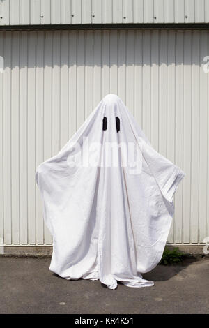 Un fantasma bianco di fronte a una porta di garage Foto Stock