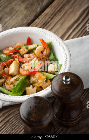 La Caesar salad con gamberi sul tavolo di legno Foto Stock