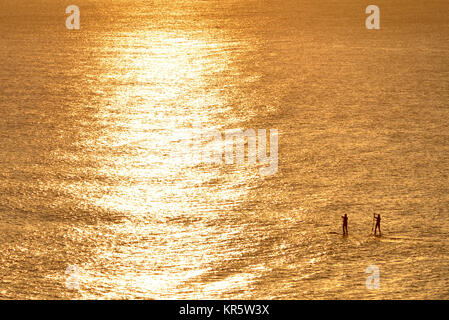 Cuckmere Haven, East Sussex. Xviii Dicembre 2017. Il sole del mattino illuminare paddle boarders vicino Cuckmere Haven su una bella mattina fresco lungo la costa del sud. Credito: Peter Cripps/Alamy Live News Foto Stock