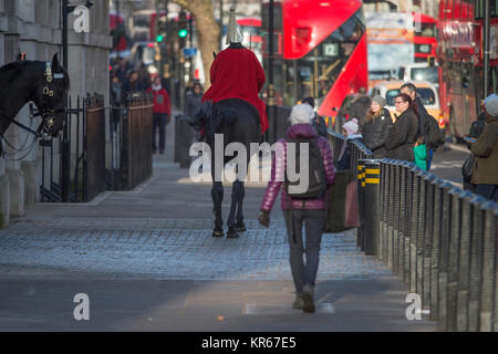 Whitehall, Londra, Regno Unito. Il 19 dicembre 2017. Una vita di protezione sulla mattina sentinella a Horse Guards ingresso porta il suo cavallo a razze torna alla garitta dopo che questa si sposta sul marciapiedi a Whitehall nella parte anteriore dei pedoni. Credito: Malcolm Park/Alamy Live News. Foto Stock