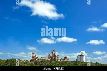 Stabilimento di trasformazione con le tubazioni e il serbatoio. Moderno edificio industriale oltre il cielo blu. fabbrica di zucchero Foto Stock