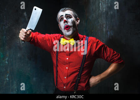 Scary clown tenendo un coltello su dack. Concetto di Halloween Foto Stock