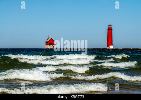 Bianco-capped waves roll passato il faro e il molo presso Grand Haven, Michigan, sul Lago Michigan Foto Stock