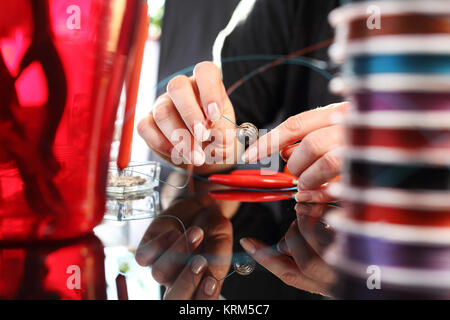 Perle di threading,gioielli workshop Foto Stock