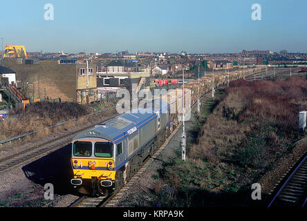 Un Foster Yeoman proprietà Classe 59 locomotore con un rastrello di vuoto tramogge di pietra passando Willesden Sud Ovest sciavero. 2° febbraio 1995. Foto Stock