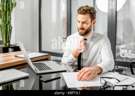 Stanco tax manager che lavora in ufficio Foto Stock