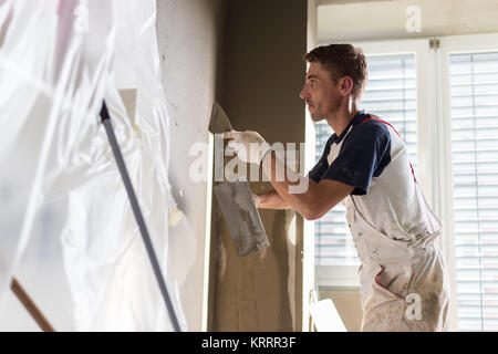 Stuccatore ristrutturando interni di pareti e soffitti. Foto Stock