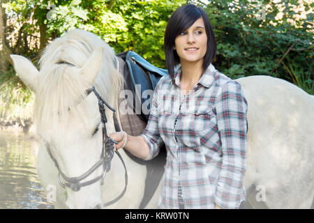 Ritratto di un bel giovane donna con il bianco equitazione Foto Stock