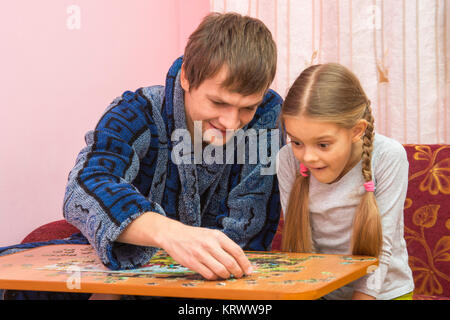 Il Papa mostra la figlia come assemblare un'immagine da puzzle Foto Stock