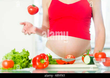 Schwangere Frau mit Gemüse - donna incinta con verdure Foto Stock