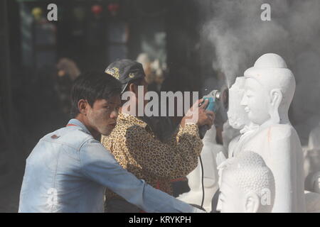 Scene di pietra-muratori alacremente il taglio e la lucidatura del marmo nei laboratori di Mandalay. Foto Stock