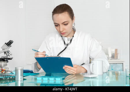 Medico in camice bianco controlli delle registrazioni pazienti Foto Stock