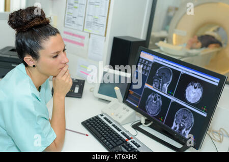 Medico donna guardando il paziente sottoposto a scansione TC Foto Stock