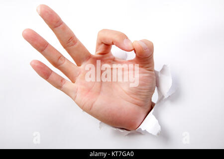 Lato punzonatura attraverso il Libro bianco e il segno ok Foto Stock