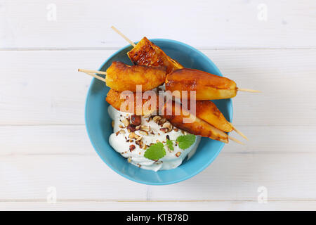 Pera e arancia spiedini con yogurt dip Foto Stock