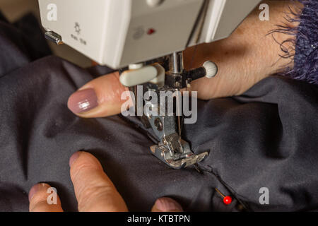 Hände beim Nähen eines Stoffes dicken Foto Stock