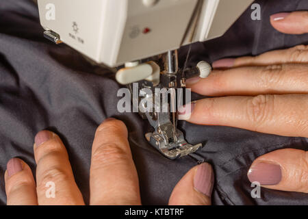 Hände beim Nähen eines Stoffes dicken Foto Stock