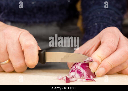 Hausfrau beim Schneiden einer roten Zwiebel Foto Stock