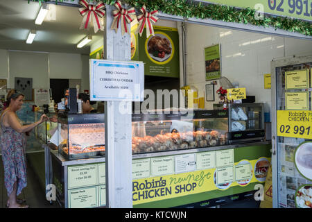 Signora in un pollo di Sydney shop ordina un pollo cotto al componente dello staff di Sydney, Australia Foto Stock