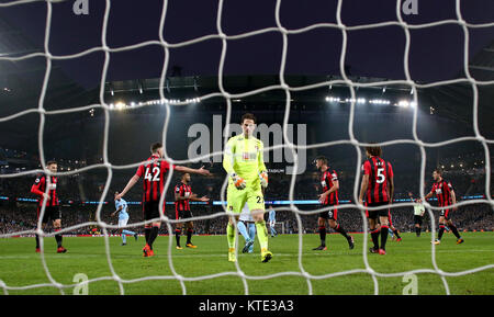 AFC Bournemouth portiere Asmir Begovic appare sconsolato dopo il Manchester City's Raheem Sterling punteggi al suo fianco il secondo obiettivo del gioco durante il match di Premier League al Etihad Stadium e Manchester. Foto Stock