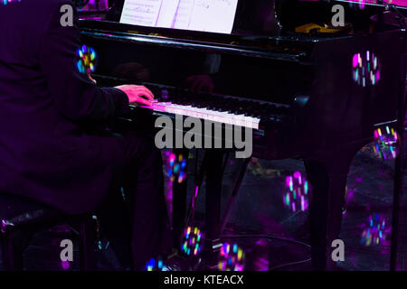 Mano a giocare sul pianoforte in concerto dura e illuminazione colorfull bolle Foto Stock