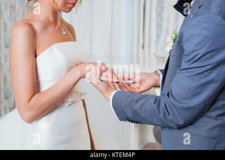 Lo sposo mette l'anello sulla sposa la mano. Ingrandimento di foto Foto Stock