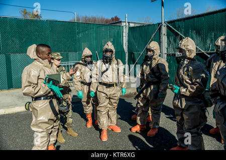 Soldati assegnato all'222nd Chemical Company, New York Army National Guard e funzionari di polizia di New York Department's COBRA (Ordinanza sui prodotti chimici, biologici e consapevolezza radiologica) unità di formazione condurre un esercizio di simulazione di un ambiente urbano attacco chimico a Rodman collo del villaggio di tattica, Bronx, N.Y., nov. 19, 2016. Il New York esercito Guardia Nazionale di soldati ed ufficiali con il cobra unità di addestramento utilizzato l'esercizio per condividere le tecniche e le procedure, nonché migliorare la loro disponibilità in caso di calamità naturali o di attacco terroristico. (U.S. Esercito nazionale Guard foto di Sgt. Harley Foto Stock