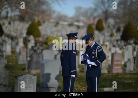 QUEENS, NY - Senior aviatori Corey Smith e Dominic Surinaga eseguire una piegatura di bandiera cerimonia al funerale per Master Sgt. Timotyh David Ryan al Cimitero di St. John nel Queens, a New York il 16 dicembre 2016. In aggiunta ad altri doveri cerimoniali, membri della 106ª Guardia d'onore sono spesso chiamati a fornire gli onori militari per Veteran's funerali. (US Air National Guard / Staff Sgt. Christopher S. Muncy / rilasciato) Foto Stock