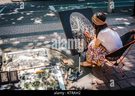 Femmina artista di strada la pittura al di fuori di Melbourne Foto Stock