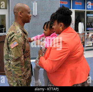 Di recente promosso New York Esercito Nazionale soldato di guardia Chief Warrant Officer 3 Nakia Duchi (sinistra), si erge come sua moglie Antionette Duchi e la figlia Tamryn Duchi perno sul suo nuovo rango insegne durante la sua cerimonia di promozione a forza comune sede a Latham, N.Y. il 10 maggio 2017. Duchi, che appartiene alla xlii Divisione di Fanteria di intelligenza e Supporto Azienda e lavora a tempo pieno come lo stato food service advisor in forza congiunta della sede centrale direzione logistica, risiede con Antionette, Tamryn e altra sua figlia Sydnee Harmon-Gamble in Clifton Park, N.Y. (Foto di Master Sgt. Raym Foto Stock