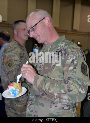 Il personale dell'esercito Sgt. Eric Pinnell, un membro del New York esercito Guardia Nazionale congiunto del quartier generale della forza di distacco gode di torta durante l esercito cerimonie compleanno a New York La Guardia Nazionale Sede il 14 giugno 2017. New York esercito nazionale i membri di guardia ha celebrato il 242compleanno dell'esercito degli Stati Uniti. (U.S. Esercito nazionale Guard foto: Sgt. Corine principali lombardo) Foto Stock