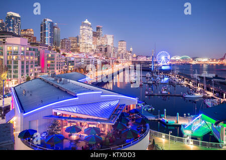 Vista in elevazione della skyline di Seattle e ristoranti in Bell Harbour Marina al tramonto, Belltown District, Seattle, nello Stato di Washington, Stati Uniti d'Americ Foto Stock