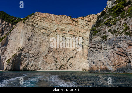 È possibile vedere i differenti strati di formazione sulle pareti rocciose delle barriere coralline e al livello del mare di sabbia e rocce beach Foto Stock