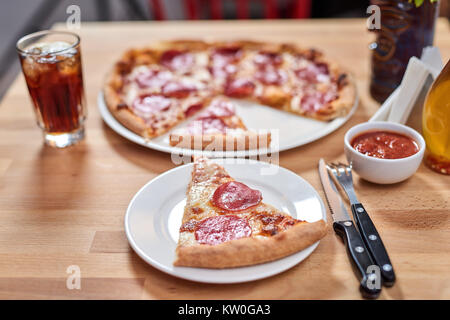 Pizza con salsiccia per pizza sul ristorante in legno tavolo. Foto Stock