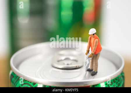 Operaio in miniatura sulla sommità del carbonato di sodio può con sfondo sfocato. Il concetto di business Foto Stock