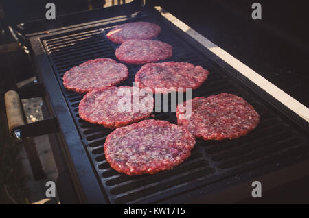 Gli hamburger sul grill barbeque. Polpette rotonde di materie carni macinate arrostito su una griglia di metallo. Foto Stock