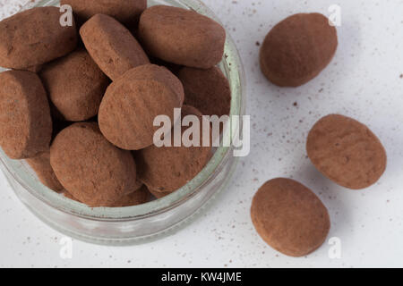 Dark cacao caramelle in una tazza su sfondo bianco Foto Stock