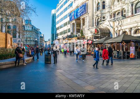 Londra dicembre 28, 2017: turisti e londinesi godere giorno soleggiato su Leicester Square, piazza pedonale che è una famosa destinazione per la notte li Foto Stock