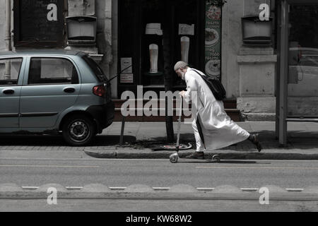Uomo arabo riding scooter in città europea street Foto Stock